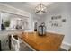 Dining area with wood table and view into kitchen and living room at 2424 W Tampa Bay Blvd # L102, Tampa, FL 33607