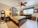 Bedroom with a ceiling fan, dresser, and a home office area at 2750 E Bay Dr # 3B, Largo, FL 33771