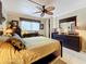 Main bedroom with ceiling fan, dresser, and large mirror at 2750 E Bay Dr # 3B, Largo, FL 33771