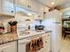 White kitchen cabinets, granite countertops, and a microwave at 2750 E Bay Dr # 3B, Largo, FL 33771