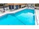 Relaxing pool area with lounge chairs and patio tables at 2750 E Bay Dr # 3B, Largo, FL 33771