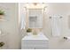 Small bathroom with white vanity, gold fixtures, and a linen towel rack at 2860 4Th S Ave, St Petersburg, FL 33712