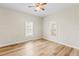 Spacious bedroom with hardwood floors and two large windows at 2860 4Th S Ave, St Petersburg, FL 33712