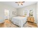 Bedroom with queen bed, en-suite bathroom access, and wood-look floors at 2860 4Th S Ave, St Petersburg, FL 33712