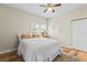 Bedroom with queen bed, wood-look floors, and ceiling fan at 2860 4Th S Ave, St Petersburg, FL 33712