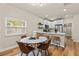 Modern white quartz dining table with leather chairs in open concept space at 2860 4Th S Ave, St Petersburg, FL 33712