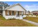 White bungalow with a covered porch and landscaping at 2860 4Th S Ave, St Petersburg, FL 33712