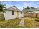 Rear view of a renovated bungalow, showcasing its white exterior and stone pathway at 2860 4Th S Ave, St Petersburg, FL 33712