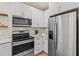 Modern kitchen with stainless steel appliances and white cabinets at 2860 4Th S Ave, St Petersburg, FL 33712