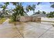 View of the side yard with a concrete parking area and wooden fence at 2860 4Th S Ave, St Petersburg, FL 33712