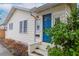 Side view of the house, highlighting the blue front door at 310 W Hilda St, Tampa, FL 33603