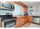 Modern kitchen boasts stainless steel appliances and light wood cabinets at 310 W Hilda St, Tampa, FL 33603