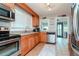 Modern kitchen with stainless steel appliances and light wood cabinets at 310 W Hilda St, Tampa, FL 33603