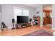 Bright living room with hardwood floors, built-in shelving, and a view into the kitchen at 310 W Hilda St, Tampa, FL 33603