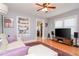 Living room features hardwood floors, a comfy sofa, built-in shelving and a ceiling fan at 310 W Hilda St, Tampa, FL 33603