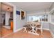 Charming sunroom with a wooden dining table and view of the kitchen at 310 W Hilda St, Tampa, FL 33603