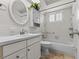 Bathroom with white vanity, tub, and a window with shutters at 3148 Domino Dr, Holiday, FL 34691