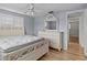 Bedroom with light blue walls, wood flooring, and white dresser at 3148 Domino Dr, Holiday, FL 34691