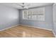 Bright bedroom with light gray walls and wood flooring at 3148 Domino Dr, Holiday, FL 34691