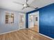 Dining room with blue accent wall and access to the kitchen at 3148 Domino Dr, Holiday, FL 34691