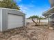 Detached garage with a white roll-up door at 3148 Domino Dr, Holiday, FL 34691