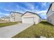 New construction home with a one-car garage and a spacious driveway at 35605 Buttonweed Trl, Zephyrhills, FL 33541