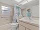 Clean bathroom featuring a shower/tub combo and updated vanity at 4994 Klosterman Oaks Blvd, Palm Harbor, FL 34683