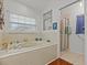 Bathroom with soaking tub and shower at 4994 Klosterman Oaks Blvd, Palm Harbor, FL 34683