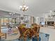 Casual dining area with a glass-top table and wicker chairs, overlooking a patio at 4994 Klosterman Oaks Blvd, Palm Harbor, FL 34683