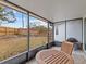 Relaxing screened porch with patio furniture and backyard view at 4994 Klosterman Oaks Blvd, Palm Harbor, FL 34683