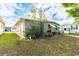 Backyard of mobile home with grass and some landscaping at 5149 Jo St, Zephyrhills, FL 33542