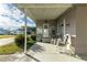 Covered patio with rocking chairs, offering a relaxing outdoor space at 5149 Jo St, Zephyrhills, FL 33542