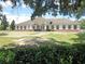 White building with brick accents, and landscaping at 5149 Jo St, Zephyrhills, FL 33542