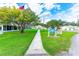 Pathway to clubhouse with American flag, lush lawn and signage at 5149 Jo St, Zephyrhills, FL 33542