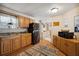 Bright kitchen with wood cabinets and black appliances at 5149 Jo St, Zephyrhills, FL 33542