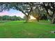 Expansive green space with mature trees and a path at 5149 Jo St, Zephyrhills, FL 33542