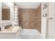 Updated bathroom with tile shower/tub combo and vanity at 5161 Rena N St, St Petersburg, FL 33709