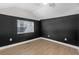 Small bedroom with dark-colored walls and wood floors at 5161 Rena N St, St Petersburg, FL 33709