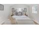 Cozy bedroom with white bedding and neutral decor at 5161 Rena N St, St Petersburg, FL 33709