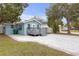 Side view of cute light blue house with a large patio at 5161 Rena N St, St Petersburg, FL 33709