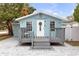 Light blue house with gray deck and paved patio at 5161 Rena N St, St Petersburg, FL 33709