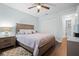 Cozy bedroom with a wood bed frame and adjacent bathroom access at 5750 80Th St N # B106, St Petersburg, FL 33709