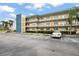 Front view of condo building with parking lot at 5750 80Th St N # B106, St Petersburg, FL 33709