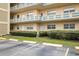 Condo building exterior with parking and landscaping at 5750 80Th St N # B106, St Petersburg, FL 33709