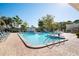 Community pool with lounge chairs and surrounding landscaping at 5750 80Th St N # B106, St Petersburg, FL 33709