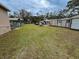 Large backyard with grassy area, sheds and playground equipment at 5805 34Th S Ave, Tampa, FL 33619