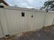 Tan vinyl fence gate with black accents and house number at 5805 34Th S Ave, Tampa, FL 33619