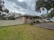 Tan house exterior with a porch and landscaping at 5805 34Th S Ave, Tampa, FL 33619