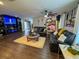 Spacious living room featuring dark leather furniture and a media wall at 5805 34Th S Ave, Tampa, FL 33619