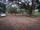 Gravel parking area with mature trees and cars at 5805 34Th S Ave, Tampa, FL 33619